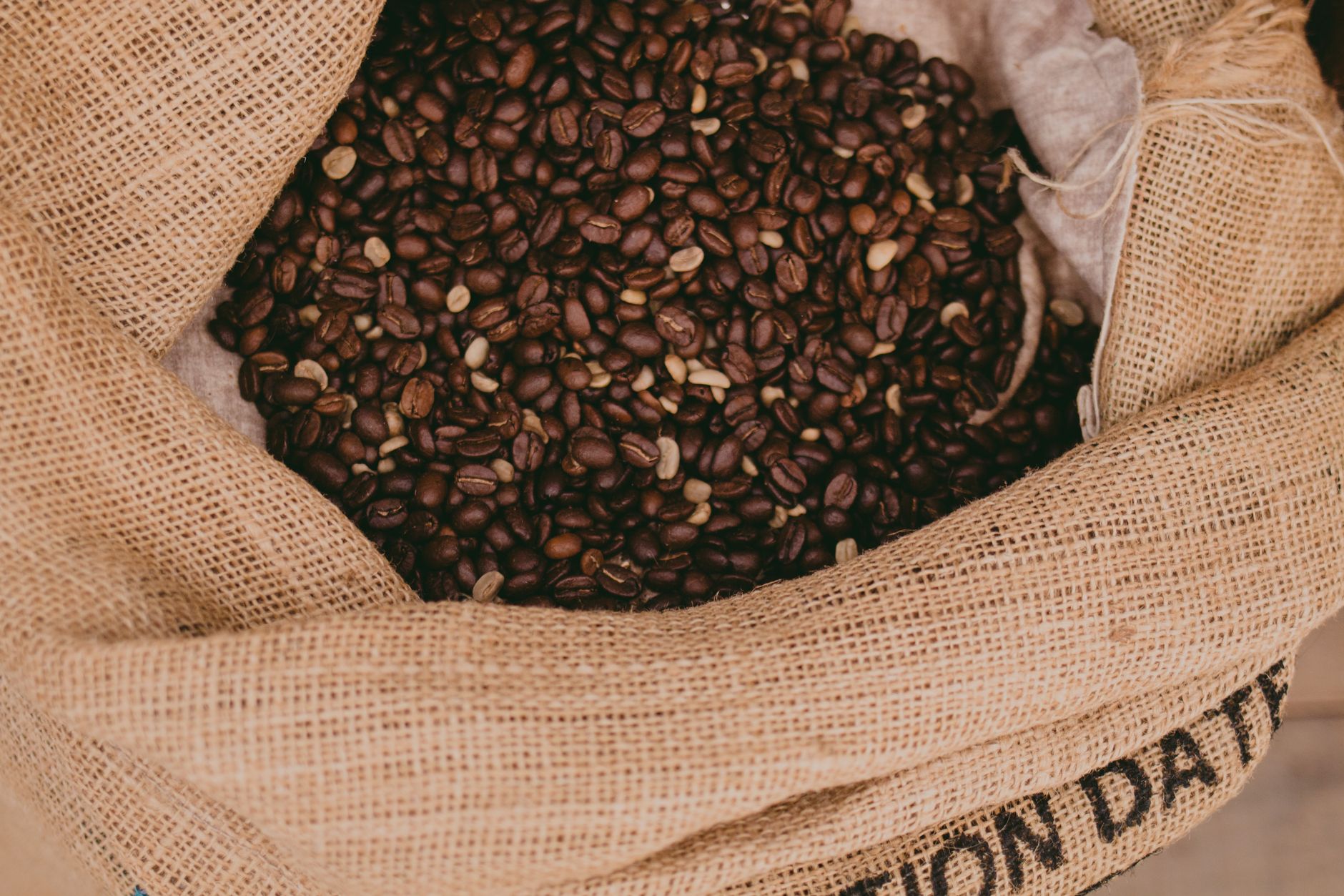 Jute sacks of graded coffee stacked for shipment