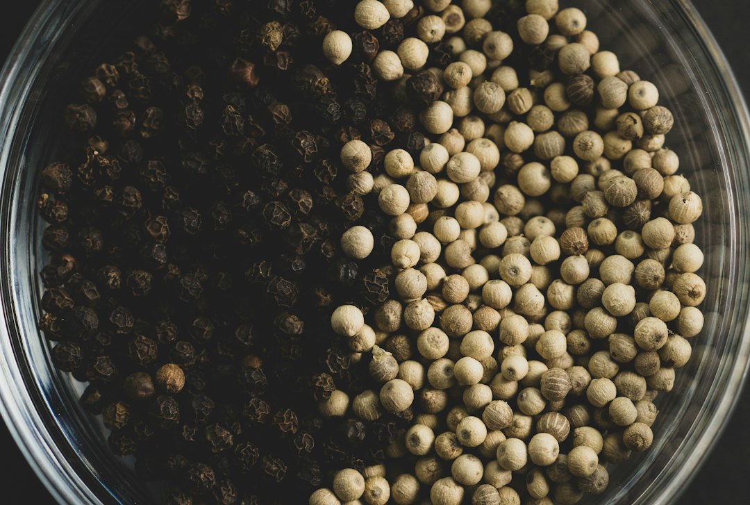 Whole black pepper and green cardamom prepared for packing